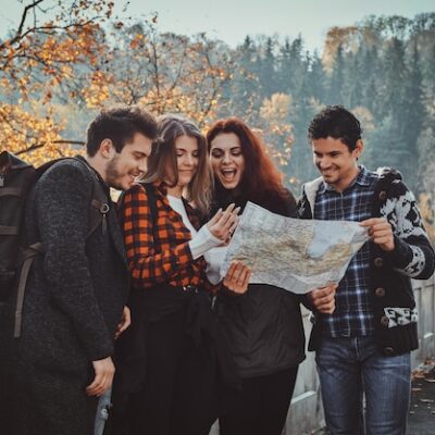 group-young-people-are-looking-map-where-they-are-while-walking-autumn-forest_613910-15159